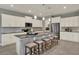 A kitchen with stainless steel appliances, granite countertops, and an island with seating at 3259 Buoy Cir, Winter Garden, FL 34787
