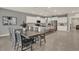 Open-concept kitchen featuring white cabinets, granite countertops, and a spacious dining area at 3259 Buoy Cir, Winter Garden, FL 34787