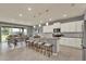 Kitchen features granite countertops, stainless steel appliances, an island with seating, and open dining area at 3259 Buoy Cir, Winter Garden, FL 34787