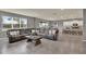 Spacious living room with modern gray color scheme, large sectional, and open floor plan with sight lines to kitchen at 3259 Buoy Cir, Winter Garden, FL 34787