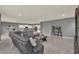 Large open-concept living room and kitchen area with stylish gray decor, tile flooring, and plenty of natural light at 3259 Buoy Cir, Winter Garden, FL 34787