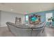 Open living room with a blue accent wall, a gray sectional, and tile flooring, perfect for entertaining at 3259 Buoy Cir, Winter Garden, FL 34787