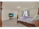 Elegant main bedroom featuring a luxurious four-poster bed, plush bedding, and ample natural light at 3259 Buoy Cir, Winter Garden, FL 34787