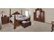 Spacious main bedroom suite featuring ornate wood furnishings, a four-poster bed, and plush carpeting at 3259 Buoy Cir, Winter Garden, FL 34787
