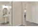Well-lit powder room featuring a modern pedestal sink, round mirror, and neutral color scheme at 3259 Buoy Cir, Winter Garden, FL 34787