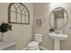 Cozy powder room featuring stylish fixtures, decorative mirror, and charming window for natural light at 3259 Buoy Cir, Winter Garden, FL 34787