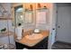 Bathroom featuring a vanity and mirror with a decorative shelf and ample lighting at 3416 Seneca Club Loop # 56, Orlando, FL 32808
