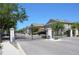 Gated community entrance with black iron gates, stone pillars, and well-maintained landscaping at 3416 Seneca Club Loop # 56, Orlando, FL 32808