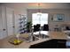 Bright dining area with wood floors, decorative shelving, and a modern glass table with seating for four at 3416 Seneca Club Loop # 56, Orlando, FL 32808