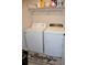 Cozy laundry area features a washer, dryer, overhead storage shelf and a laundry-themed floor mat at 3416 Seneca Club Loop # 56, Orlando, FL 32808