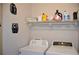 Well-equipped laundry room with a washer, dryer, and storage shelves for laundry supplies at 3416 Seneca Club Loop # 56, Orlando, FL 32808