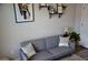 Comfortable living area with a gray sofa, stylish pillows, and modern decor at 3416 Seneca Club Loop # 56, Orlando, FL 32808