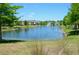 Serene pond view featuring a fountain, lush greenery, and residential buildings in the background at 3416 Seneca Club Loop # 56, Orlando, FL 32808