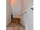 A bright stairway with wood-look steps, white walls, and dark hardware at 3416 Seneca Club Loop # 56, Orlando, FL 32808