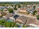 Aerial view of the home with a screened-in pool in a residential neighborhood at 386 Riggs Cir, Davenport, FL 33897