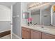 Bathroom featuring a mirror, sink, and vanity with pink flowers and a view to the shower at 386 Riggs Cir, Davenport, FL 33897