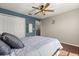 Bedroom featuring a ceiling fan, closet, and queen bed with wood-look floors at 386 Riggs Cir, Davenport, FL 33897