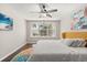 Inviting bedroom with a queen bed, ceiling fan, and abundant natural light from the window at 386 Riggs Cir, Davenport, FL 33897