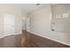 Empty room with an open doorway and hardwood floors at 386 Riggs Cir, Davenport, FL 33897