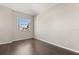 Empty bedroom with hard wood floors and a large window with backyard views at 386 Riggs Cir, Davenport, FL 33897