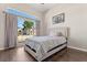 Charming bedroom featuring a large window, and comfortable bed with hardwood floors at 386 Riggs Cir, Davenport, FL 33897