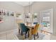 Cozy dining room with stylish chairs, modern light fixture, and access to the outdoors at 386 Riggs Cir, Davenport, FL 33897