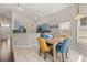 Open dining area connecting to the kitchen, featuring natural light and stylish decor at 386 Riggs Cir, Davenport, FL 33897