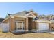 Charming two-story home featuring a well-manicured lawn and attached two-car garage at 386 Riggs Cir, Davenport, FL 33897