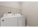 Bright laundry room features a stacked washer and dryer and ample shelving at 386 Riggs Cir, Davenport, FL 33897