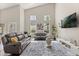 Bright living room featuring vaulted ceilings, stylish furniture, and natural light at 386 Riggs Cir, Davenport, FL 33897