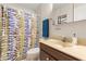 Cozy bathroom with a colorful shower curtain, vanity, and ample lighting at 4495 Bedford Rd, Sanford, FL 32773
