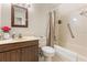 Well-lit bathroom with a single sink vanity, standard toilet, and a shower with a curtain at 4495 Bedford Rd, Sanford, FL 32773