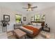 Spacious bedroom featuring a ceiling fan, windows, and an orange blanket on the bed at 4495 Bedford Rd, Sanford, FL 32773