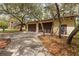 Exterior view of a two car garage with a long driveway and mature trees at 4495 Bedford Rd, Sanford, FL 32773