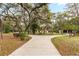 Home with a circular driveway, mature trees, lush landscaping and a detached garage at 4495 Bedford Rd, Sanford, FL 32773