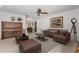 Well-lit living room featuring a ceiling fan, neutral paint, and comfortable brown furniture at 4495 Bedford Rd, Sanford, FL 32773