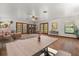 Open living space featuring wood floors, French doors, modern furniture, and natural light at 4495 Bedford Rd, Sanford, FL 32773