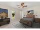 Relaxing bedroom featuring a queen-size bed, natural light, and modern decor at 4495 Bedford Rd, Sanford, FL 32773