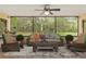 Screened patio with comfortable seating and ceiling fan overlooking the lush green backyard at 4495 Bedford Rd, Sanford, FL 32773