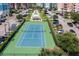 Aerial view of a community featuring a tennis court, bocce ball court, and colorful condo buildings at 5 Riverwalk Dr # 604, New Smyrna Beach, FL 32169