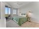 Cozy bedroom has a ceiling fan, balcony access, and stylish bedside lighting fixtures at 5 Riverwalk Dr # 604, New Smyrna Beach, FL 32169