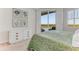 Bright bedroom boasts water views, a modern dresser, and a sliding glass door at 5 Riverwalk Dr # 604, New Smyrna Beach, FL 32169