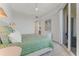 Bright bedroom featuring balcony access, seascape artwork, and neutral tones at 5 Riverwalk Dr # 604, New Smyrna Beach, FL 32169