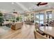 Spacious common area with stylish seating, dining tables, ceiling fans, and views of the community pool at 5 Riverwalk Dr # 604, New Smyrna Beach, FL 32169