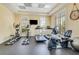 Well-equipped fitness center with treadmills, elliptical machines, recumbent bike, and natural light at 5 Riverwalk Dr # 604, New Smyrna Beach, FL 32169