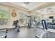 Well-equipped fitness center with weight machines, treadmill, mirror, exercise bike, and natural light at 5 Riverwalk Dr # 604, New Smyrna Beach, FL 32169