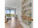 Hallway with built in bookshelves with designer wallpaper and luxury tile flooring at 5 Riverwalk Dr # 604, New Smyrna Beach, FL 32169