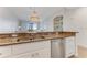 Bright kitchen features stainless steel appliances, granite countertops, and an elegant chandelier at 5 Riverwalk Dr # 604, New Smyrna Beach, FL 32169