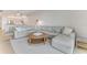 Relax in this bright and airy living room with a plush sectional, neutral decor and scenic water views at 5 Riverwalk Dr # 604, New Smyrna Beach, FL 32169