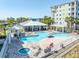 Aerial view of a resort-style pool with cabanas, lounge chairs, spa, and a view of the surrounding buildings at 5 Riverwalk Dr # 604, New Smyrna Beach, FL 32169